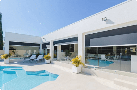 Weather-resistant exterior shades providing sun protection and privacy by Bloomin' Blinds