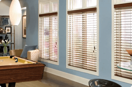 Elegant red oak finish wood blinds adding warmth and style to windows by Bloomin' Blinds