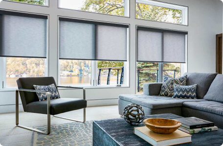 Sleek roller shades offering light control and privacy by Bloomin' Blinds